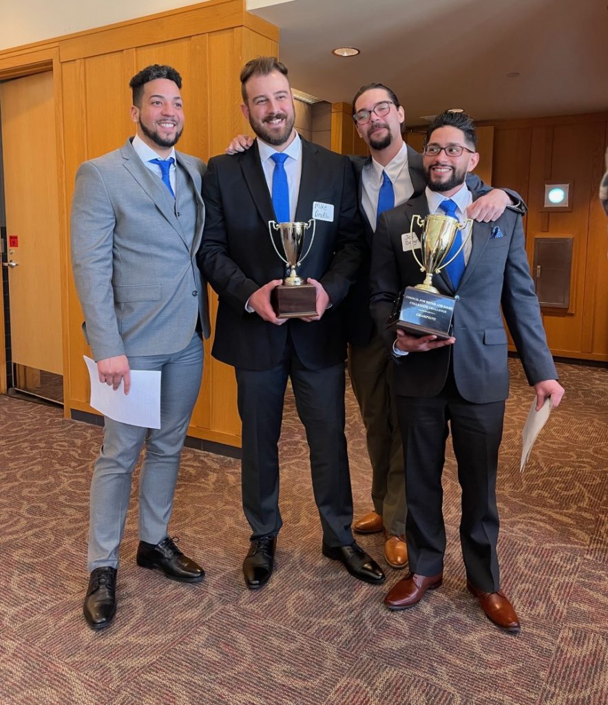 4 men holding trophy