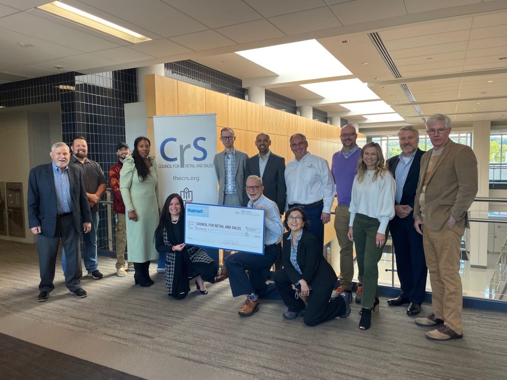 Group of people holding a large check.